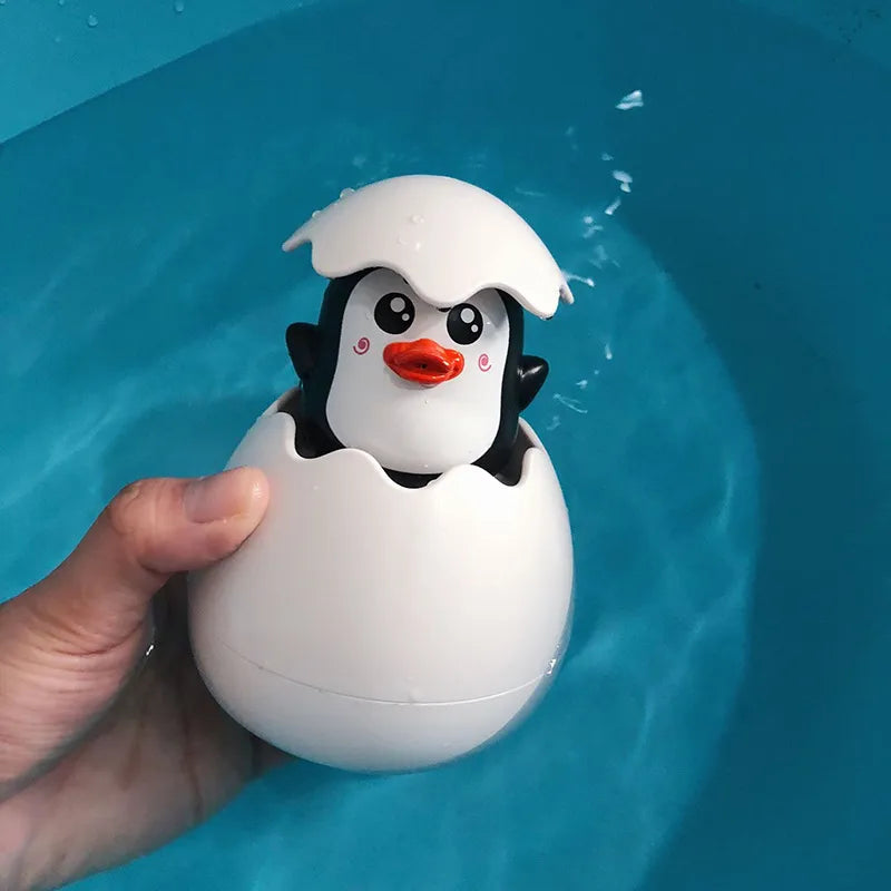 Juguete de Baño para Bebés: Divertido Patito Pingüino con Huevo de Agua - Juguete de Rociador para la Ducha, Piscina y Regalo Infantil